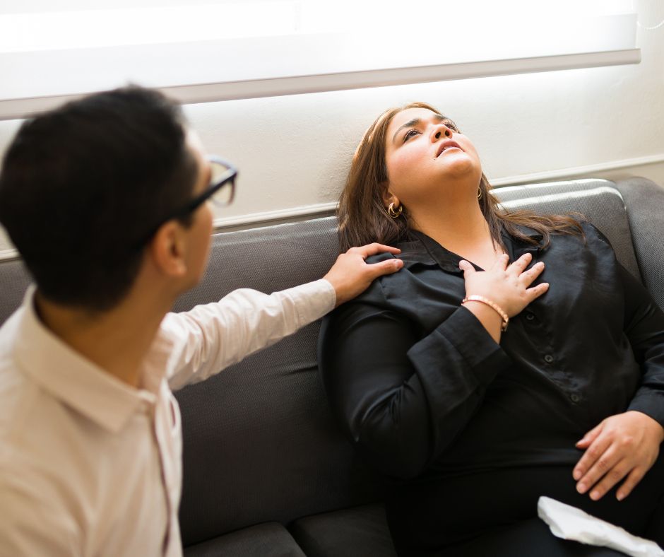 A female experiencing a panic attack is comforted by a male