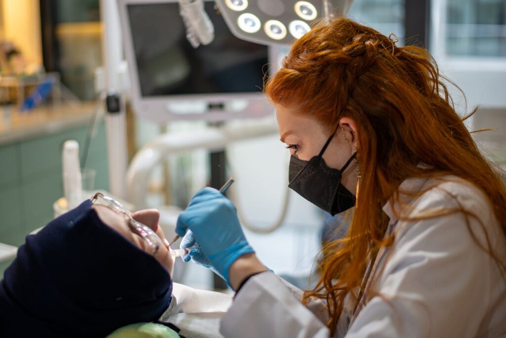 A dentist performs a thorough examination of a patient's teeth, ensuring comprehensive dental care and maintenance.