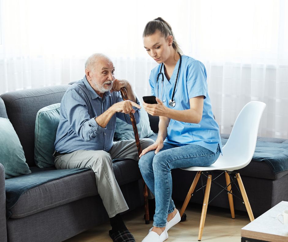 An old man with Alzheimer's Disease gets assistance from a female nurse. 